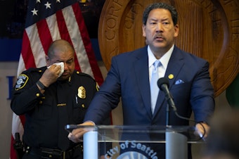 caption: Former police chief Adrian Diaz wipes a tear following Mayor Bruce Harrell’s announcement that he would be stepping down as Seattle’s Chief of Police on Wednesday, May 29, 2024, at City Hall in Seattle. 