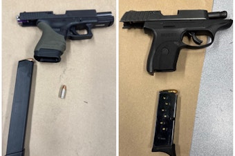 caption: Two semi-automatic handguns Seattle police say they seized while arresting a 17-year-old in Rainier Beach on May 11, 2024.