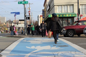 caption: Visitors to Little Saigon in Seattle's Chinatown International District use a decorative crosswalk at the intersection of 12th Avenue South and South Jackson Street.