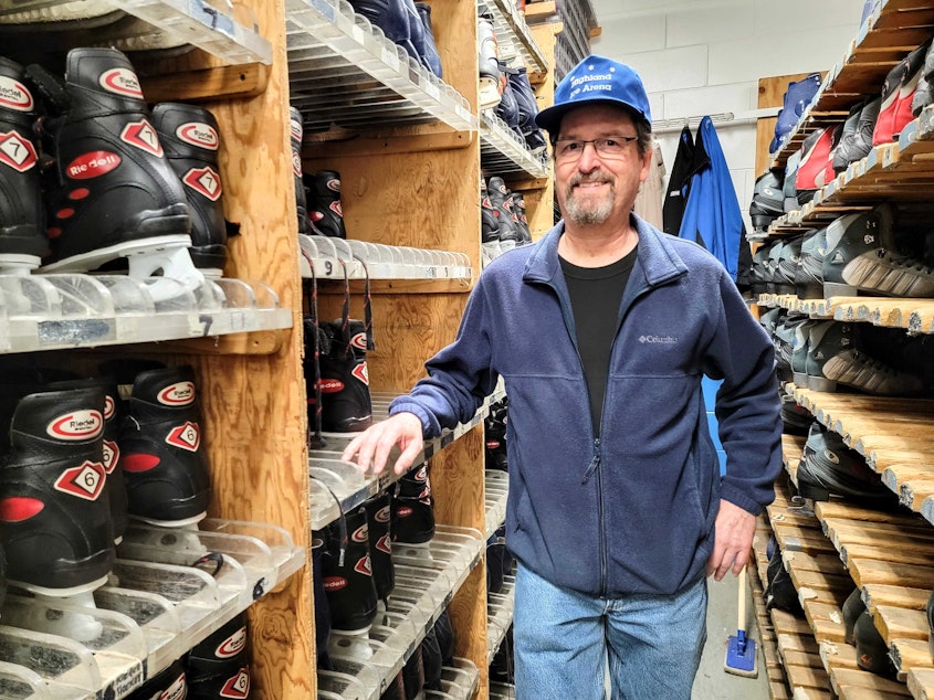 caption: Chris Freas, aka Mr. Freeze, stands with the rental skates at Highland Ice Arena on Wednesday, Oct. 12, 2022.