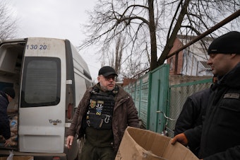 caption: Serhii Chaus, the mayor of the eastern Ukrainian city of Chasiv Yar, arrives at a bread delivery location on the outskirts of town. Chaus goes daily into the embattled town to deliver supplies and meet residents who choose to stay there as Russian forces are approaching the area.