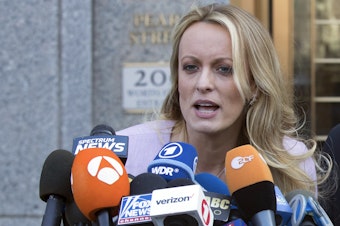 caption: Adult film actress Stormy Daniels speaks outside federal court in New York in April 2018. She is testifying this week in the criminal trial of former President Donald Trump.