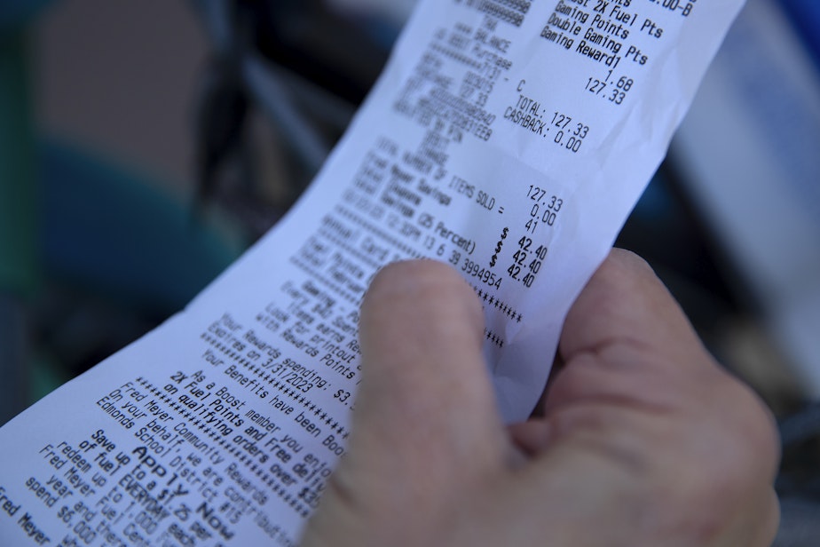 caption: Diane Martin Rudnick checks her receipt Thursday, February 23, 2023, at Fred Meyer along Aurora Avenue North in Shoreline.