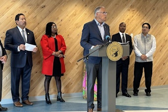 caption: Along with officials from King County and Seattle, Washington Gov. Jay Inslee announces the Washington Families Clean Energy Credits grant program on July 29, 2024. The program offers a $200 utility bill credit to low- to moderate-income households. 