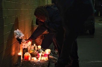 caption: Dozens of mourners gathered on Saturday, Dec. 21, 2024 for a vigil honoring slain King County Metro bus driver Shawn Yim. 