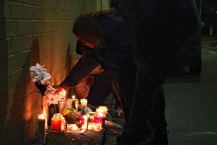 caption: Dozens of mourners gathered on Saturday, Dec. 21, 2024 for a vigil honoring slain King County Metro bus driver Shawn Yim. 