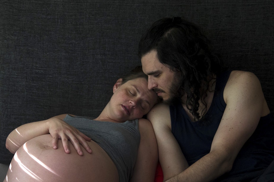 caption: Hope Black rests her head on her husband Jake Black's shoulder after a long night of labor, at 8:37 a.m., on Friday, May 28, 2020, at their home on Vashon Island. 