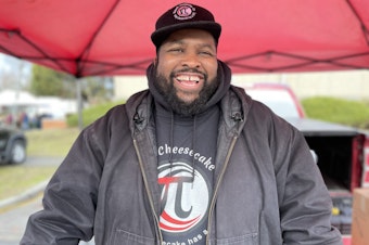 caption: Michael Mason, who goes by "Chef Mason" selling cheesecake and talking community at the Proctor Farmers Market in Tacoma