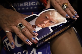 caption: Lisa Miller, a Trump follower, shows her nails at the WAGOP Election Night Watch Party in Bellevue, WA. Nov. 5, 2024