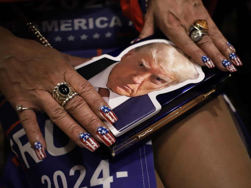 caption: Lisa Miller, a Trump follower, shows her nails at the WAGOP Election Night Watch Party in Bellevue, WA. Nov. 5, 2024