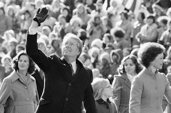 caption: President Jimmy Carter waves to the crowd while walking with his wife, Rosalynn, and their daughter, Amy, along Pennsylvania Avenue from the Capitol to the White House following his inauguration in Washington, D.C., on Jan. 20, 1977. On the following day, he issued a pardon for people who had evaded the Vietnam War draft.