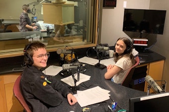 caption: Gideon Hall and Ada Walther, graduates of RadioActive's 2022 Intro to Radio Journalism Workshop and the hosts of this showcase, in the KUOW studios.