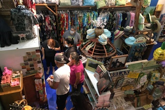 caption: Customers clamor for Hawaiian lei. The Hawai'i General Store in Seattle was at capacity on Saturday, June 12, 2021.