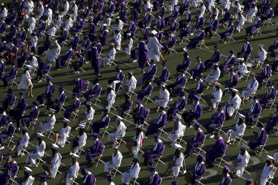 caption: Garfield High School seniors graduate in-person on Tuesday, June 15, 2021, at Memorial Stadium in Seattle. 