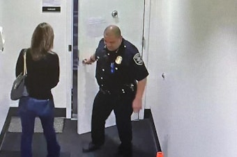 caption: Former Chief Adrian Diaz opens the door to the parking garage for former newsanchor Jamie Tompkins at Seattle Police headquarters on New Years Eve 2022. For the next two years, they would be the subject of gossip and intrigue about their relationship.