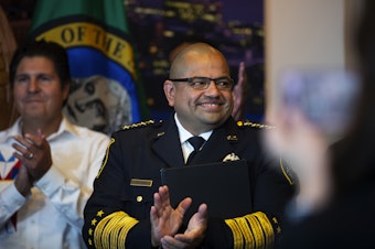 caption: Adrian Diaz smiles and claps during a press conference where he was announced by Seattle mayor Bruce Harrell as the new permanent Seattle Police Chief on Tuesday, September 20, 2022, at Seattle City Hall. 