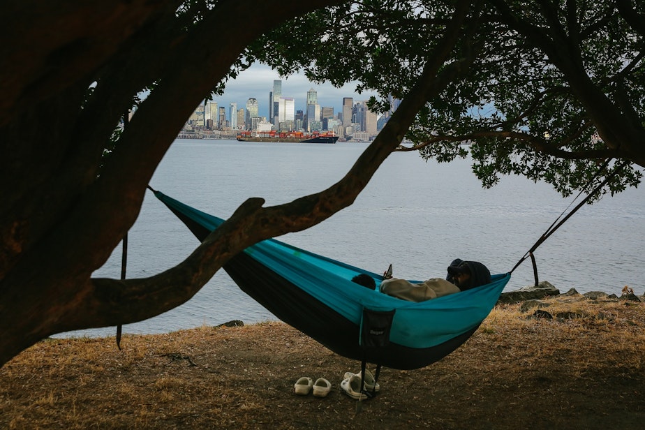 caption: Christian Zumbado and Monse Aguilar relax in a hammock off of Harbor Avenue SW in the Alki neighborhood of West Seattle, September 14, 2021.