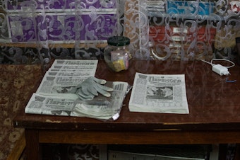 caption: Editions of <em>Peremoha</em> sit on a table near the archives.