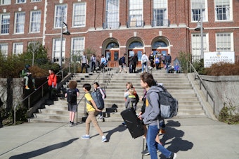 caption: Students leave Hamilton International Middle School on  March, 11, 2020, after Seattle Public Schools decided to close all school buildings in response to the Covid-19 pandemic.