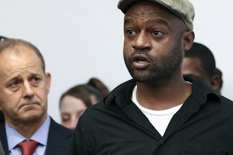 caption: Jeffery Christian, right, speaks at a press conference in Chicago, on May 7. Christian and dozens of others claim they were sexually abused as children while incarcerated at Illinois juvenile detention centers, as part of a lawsuit recounting decades of allegations of systemic child abuse.