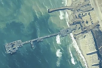 caption: The image provided by U.S, Central Command, shows U.S. Army soldiers, U.S. Navy sailors and Israel Defense Forces placing the Trident Pier on the coast of Gaza Strip on Thursday.