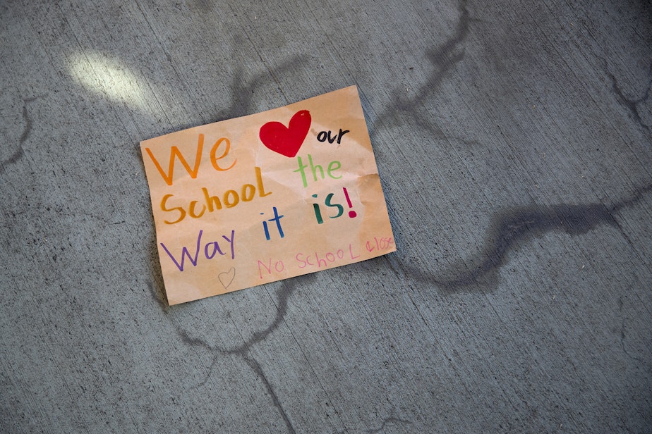 caption: "We love our school the way it is," reads a handwritten sign as hundreds of parents and students rallied to demand that schools remain open, ahead of the Seattle Public Schools board meeting on Wednesday, Sept. 18, 2024, at the John Stanford Center for Educational Excellence building in Seattle. 