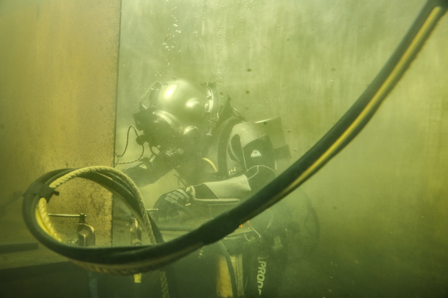 caption: Student William Holcomb does an underwater welding exercise in a diving tank at the Diver's Institute of Technology.