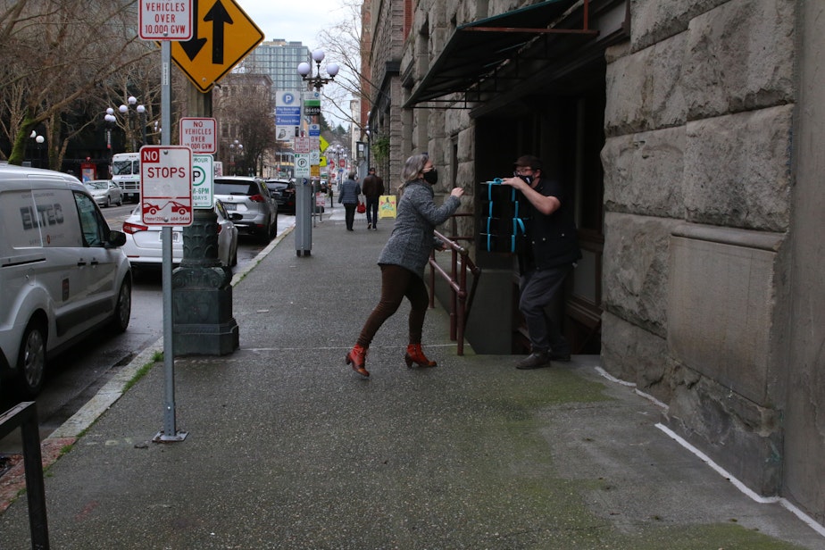 caption: Erin Brindley and Terry Podgorski of Cafe Nordo hand off boxes to be delivered to customers during the Covid-19 pandemic in 2021.