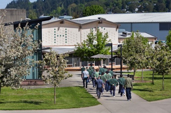 caption: Offenders are escorted across campus at Green Hill School in Chehalis, Wash. on Wednesday, May 10, 2017. Green Hill School is a medium/maximum security, fenced facility for teenage male offenders run by the State Department of Social and Health Services.