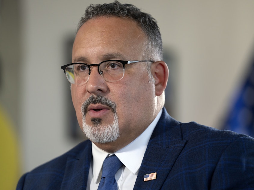 caption: Education Secretary Miguel Cardona speaks during an interview with The Associated Press in his office at the Department of Education, Sept. 20, 2023, in Washington, D.C.