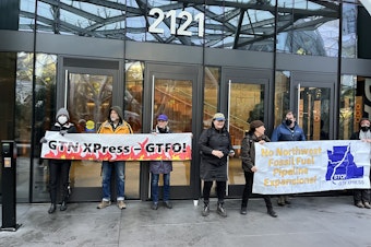 caption: Amazon has canceled plans to use natural gas from a proposed pipeline expansion in Oregon, something activists called for during a protest at company headquarters in March 2024. 