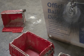 caption: A damaged ballot drop box is displayed during a news conference at the Multnomah County Elections Division office on Monday, Oct. 28, 2024, in Portland, Ore. 