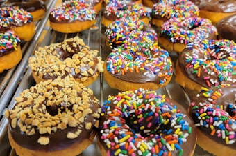 caption: Peanut and sprinkle-covered donuts are as fancy as they get at Kirkland's Countryside Donuts.