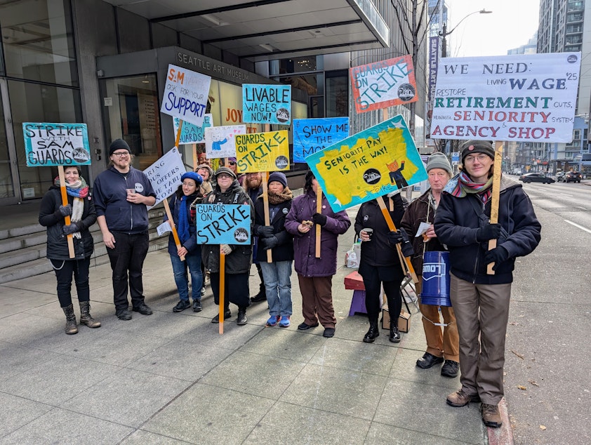 caption: Seattle Art Museum gallery guards picket outside the building entrance Wednesday, Dec. 4, 2024.