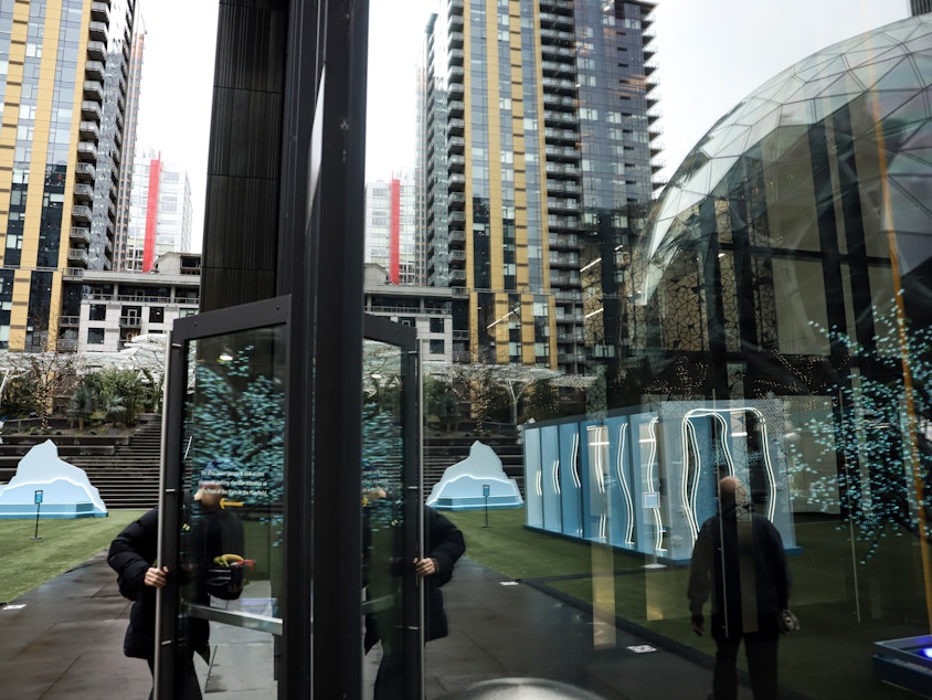 caption: Amazon employees returned to work en masse in downtown Seattle Thursday after a companywide policy went into effect requiring most workers to be in the office five days a week.