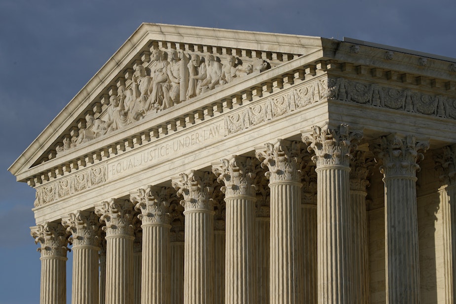 caption: In this May 3, 2020 photo, the setting sun shines on the United States Supreme Court building on Capitol Hill in Washington.