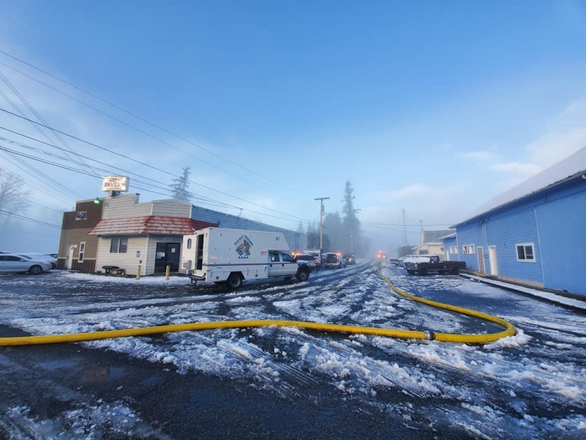 caption: A firefighting hose snakes through downtown Custer, Washington, on Dec. 22.