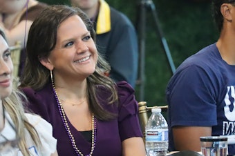 caption: Rep. Tarra Simmons (D-Bremerton) sits in the crowd listening to a person speak at her celebration event in Bremerton Friday, Sept. 8, 2023, after having her criminal record cleared by a judge earlier that afternoon.