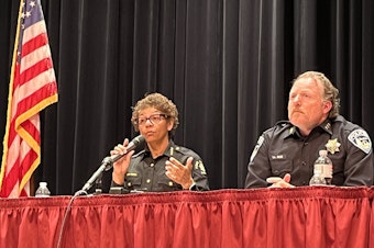 caption: King County Sheriff Patti Cole-Tindall, left, and then-Burien Police Chief Ted Boe speak at a meeting organized by KCSO to discuss Burien's camping ban on May 6, 2023. Cole-Tindall said that night, “I have issues with that ordinance, I’m not sure it’s constitutional."