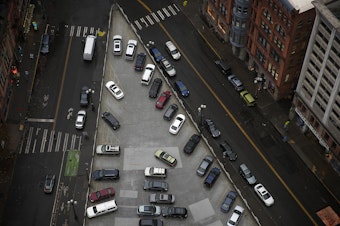 caption: Cars are shown parked from the Smith Tower observatory on Friday, December 1, 2017, in Seattle. 