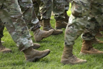 caption: FILE- In this April 3, 2017, file photo U.S. Army soldiers march in formation during a change of command ceremony at Joint Base Lewis-McChord in Washington. 