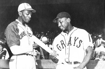 caption: Satchel Paige of the Monarchs talks with Josh Gibson of the Homestead Grays before a game in Kansas City in 1941.
