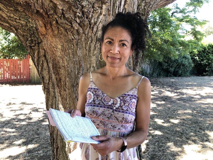 caption: Gretchen Yanover holds the journal she kept on the advice of a counselor to cope with stress while living at Cedar Crossing in Seattle. 