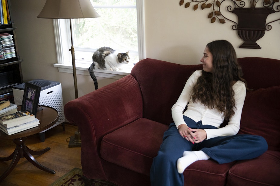 caption: Katie Ferguson, 16, with her cat Peter, on Tuesday, September 3, 2024, at their home in Northeast Seattle.