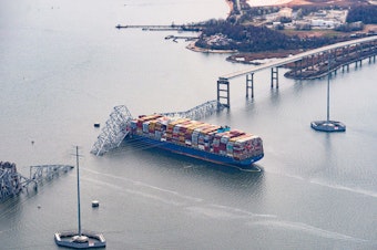 caption: The Dali container vessel after striking the Francis Scott Key Bridge that collapsed into the Patapsco River in Baltimore, on Tuesday. The Port of Baltimore, which has the highest volume of auto imports in the U.S., is now temporarily closed.