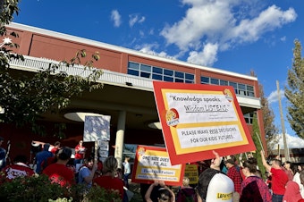 caption: Over 100 Seattle parents, students, teachers, and community members rallied against school closures ahead of a school board meeting Oct. 9, 2024. 