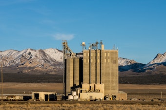 caption: The Smithfield feed processing mill producing food for nearby hog-raising farms in Milford, Utah.