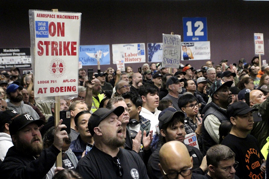 caption: Boeing machinists, labor allies and elected officials rally in Seattle at their union hall on Tuesday, Oct. 15, 2024.