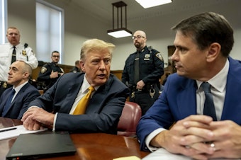 caption: Former President Donald Trump appears in court with attorneys Emil Bove (left) and Todd Blanche (right) for his trial for allegedly covering up hush money payments at Manhattan criminal court on Tuesday in New York City.