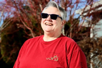 caption: Penny Maibie poses for a portrait outside her Maple Valley home.